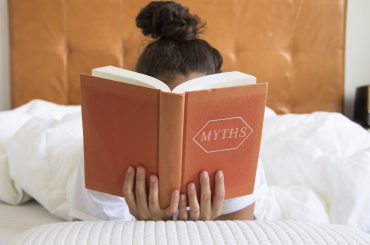 Person reading with book in front of face
