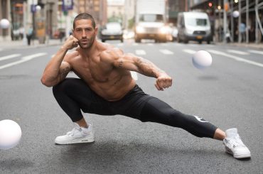 Neiman in stretching pose on street